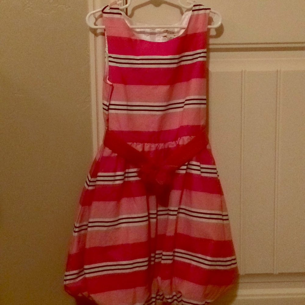 Children place pink striped dress